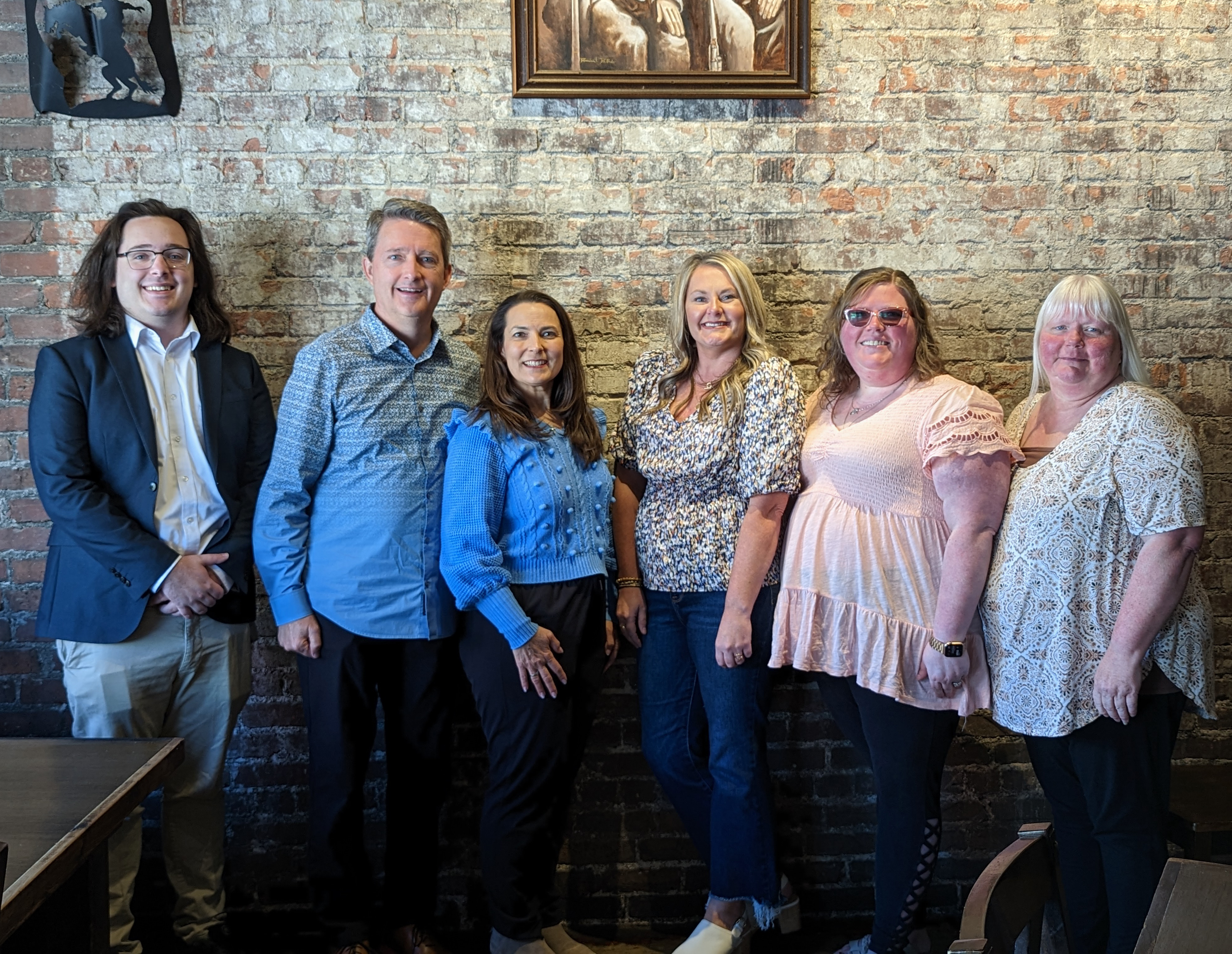 Sky reflects onto full lake surrounded by mountains